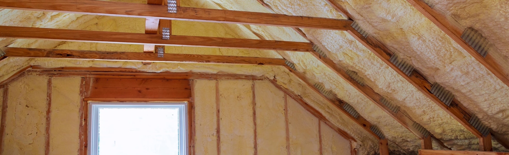Exposed insulation in an attic room